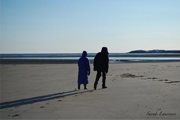 people walking on beach in winter photo by Sarah Laurence